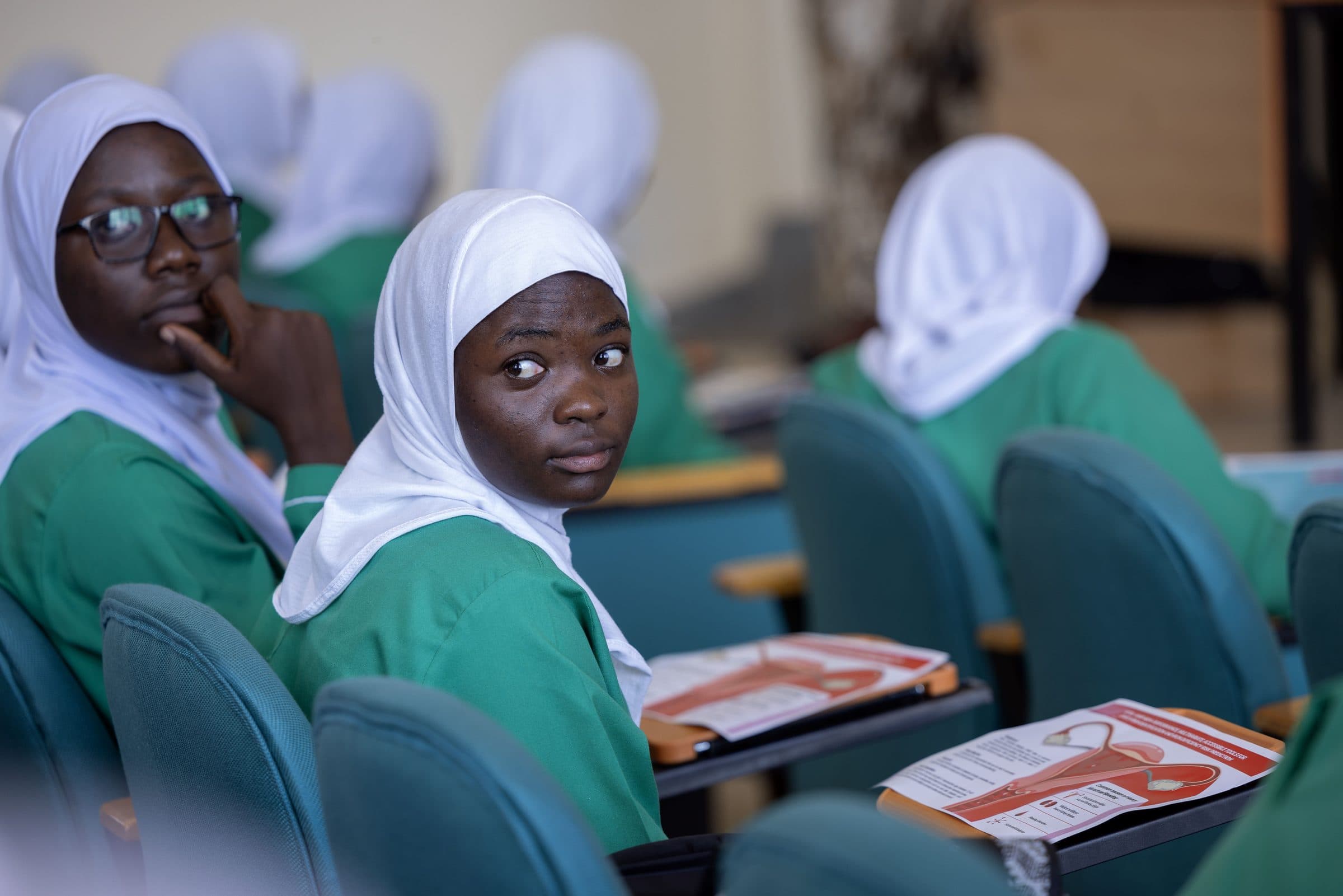 Students with study information leaflets at a school session
